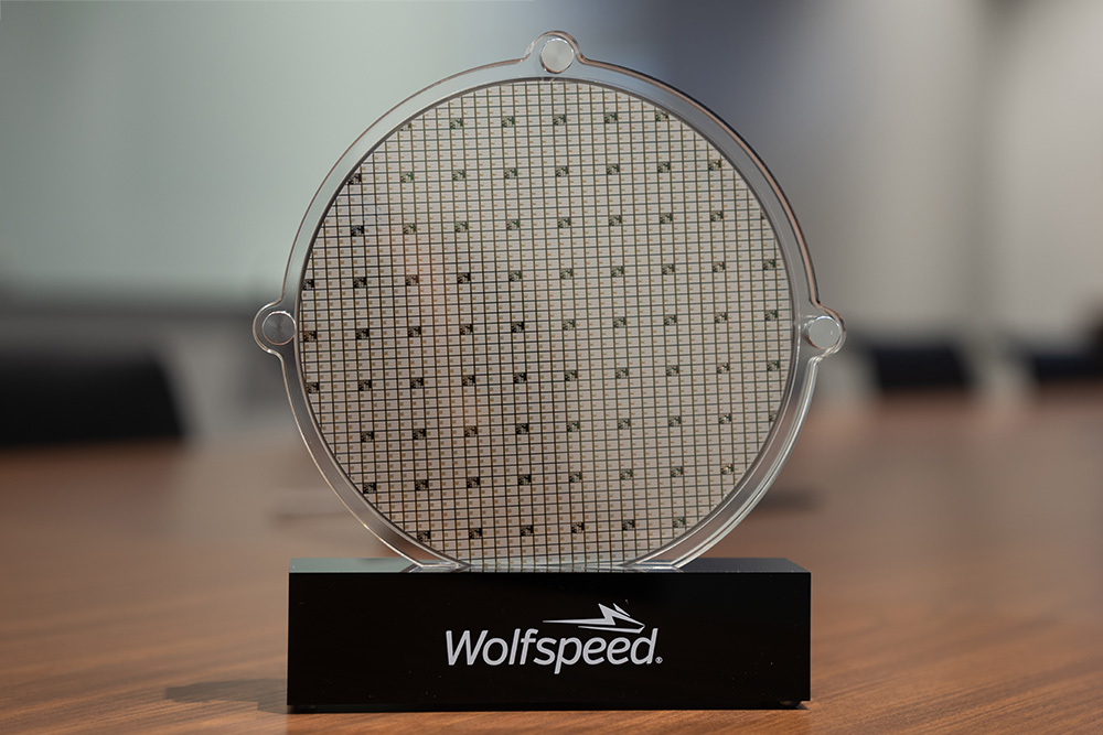 Close up product photo of a silicone carbide wafer and branded stand. 